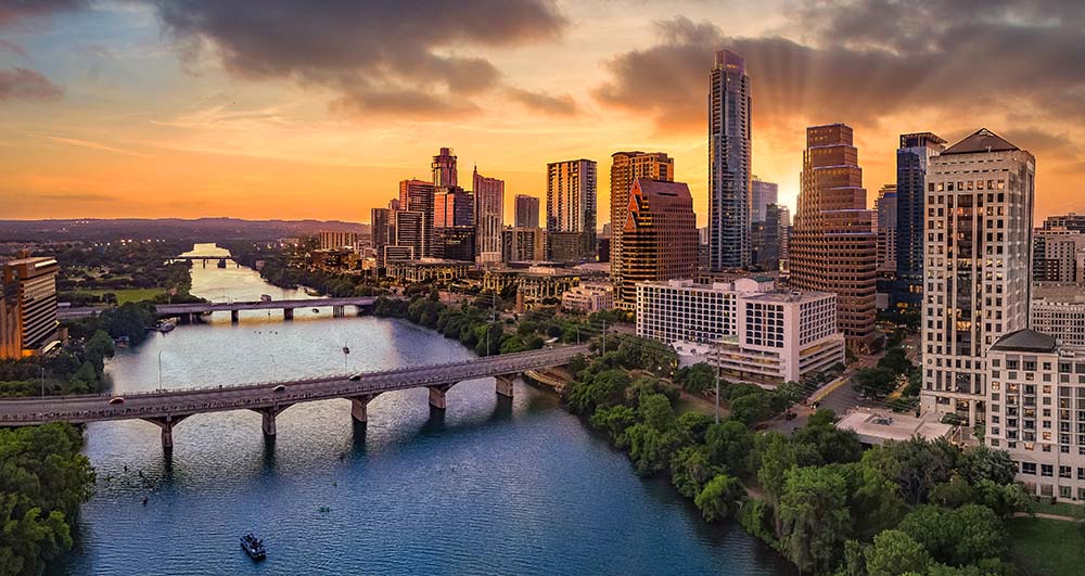Austin, Texas skyline at sunset along Texas Colorado River